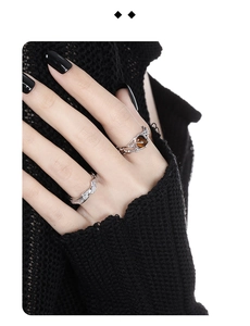 Detail of S925 sterling silver rings with bubble texture and brown gemstone on hand