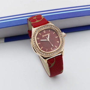 Close-up of luxury square quartz watch with rose gold diamond bezel and red leather strap