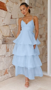 Detail of light blue layered chiffon maxi dress with thin straps and ruffled cake hem