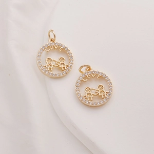 Close-up of 14K gold plated circular LOVE pendants with zircon stones and etched figures