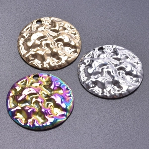 Detailed view of round hammered metal pendants in gold, silver and rainbow finishes