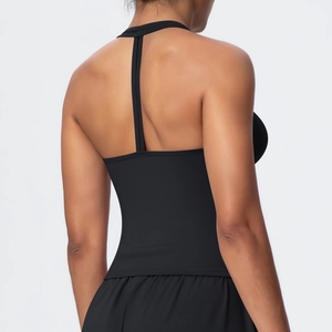 Detailed back view of a black T-back yoga top showing high-elasticity fabric and fit