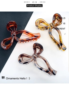 Detailed view of three oversized bow hair claws in tortoiseshell and leopard patterns