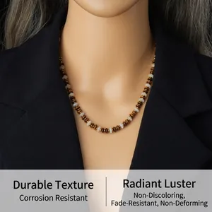 Detail of beaded necklace with tiger eye resin beads and stainless steel chain