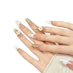 Elegant almond press-on nails with 3D white flowers, lace patterns, and crystal accents