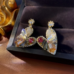 Exquisite gold heart earrings with colorful crystals and pearls in a jewelry box