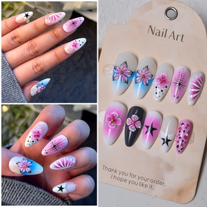 Detail of almond nails with 3D cherry blossom relief and gradient design