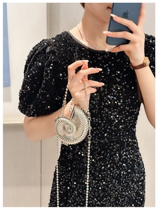 Detailed view of silver shell-shaped mini bag with spiral texture and metal chain strap