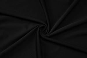 Close-up of soft black lace and elastic knit fabric texture with elegant draping