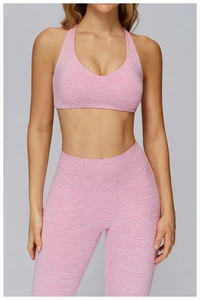 Close-up of pink brushed marl fabric texture on high-waist leggings and sports bra