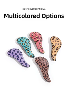 Detail of ergonomic leopard print hair brushes in purple, turquoise, pink, and yellow