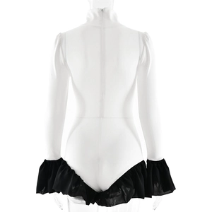 Detail view of the back zipper and black ruffled hem on the white high neck bodysuit
