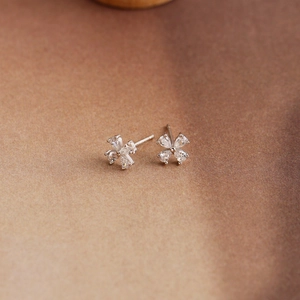 Macro shot of a minimalist S925 silver flower stud earring with pear-cut zircon petals