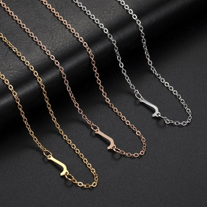 Detail of O-chain necklace ends in gold, rose gold and silver finishes on black leather