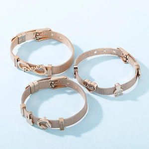 Detail of rose gold mesh bracelets with rhinestone crown and heart pendants