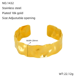 Detailed close-up of 20mm wide hammered texture on 18k gold plated stainless steel bangle