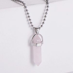 Close-up of pink crystal hexagonal pillar pendant with a silver bead chain necklace