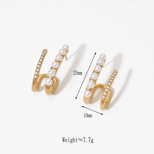 Detail view of double-layered earrings with white pearls and sparkling zircons