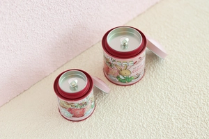 Detailed top view of pink and burgundy mini tin boxes showing double-lid structure