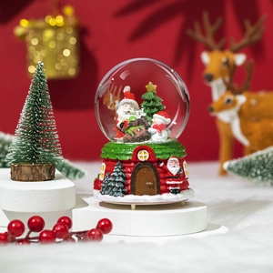 Close-up of a musical Christmas crystal ball featuring Santa and snowman in a snowy scene