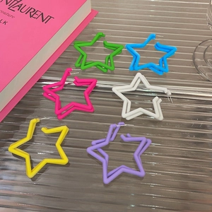 Macro view of colorful star earrings in green, blue, pink, white, yellow, and purple