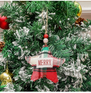 Close-up of star-shaped Christmas ornament with red-green plaid fabric and fringe