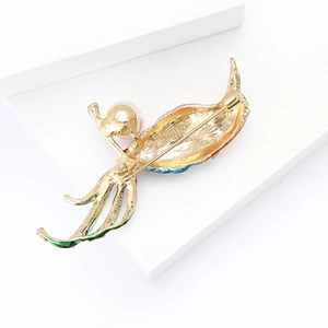 Detailed back view showing metal pin clasp and colorful enamel bird brooch craftsmanship