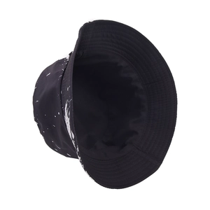 Foldable ink print bucket hat with black and white splatter design for outdoor sun protection