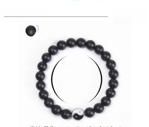 Detail of 10mm matte black stone beaded bracelet with Yin Yang charm and size specs