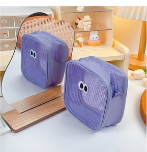 Close-up of a purple mesh makeup bag featuring cute big eyes and a zipper closure