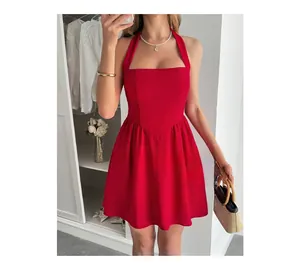 Detail of red halter neck mini dress with inverted V-waist and pleated A-line skirt
