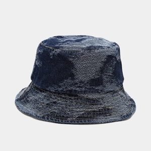 Detailed macro view of vintage dark blue washed denim fabric with frayed fringe edges