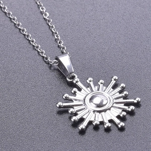 Macro shot of sunburst pendant necklace in silver stainless steel finish