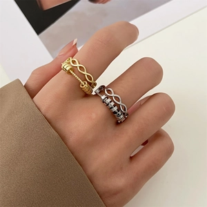 Rotating fidget ring with infinity symbol and zircon stones in gold and silver finish