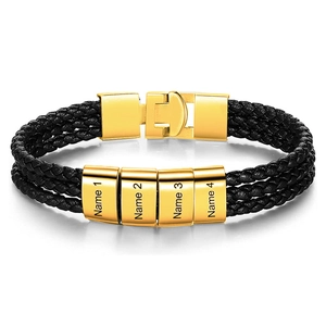 Close-up of triple-layered black braided leather bracelet with four gold engraved nameplates