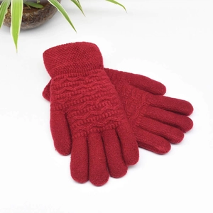 Close-up of red wave-patterned knit gloves showing thick thermal fleece lining details