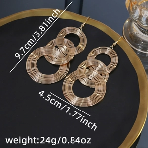 Macro shot showing dimensions of large gold geometric layered hoop earrings