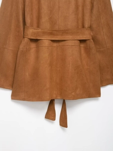 Detail shot of brown faux suede jacket featuring back belt and hem tie accents