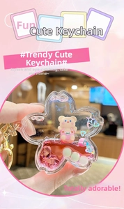 Detail view of flower-shaped liquid glitter keychain with a cute bear and pink quicksand