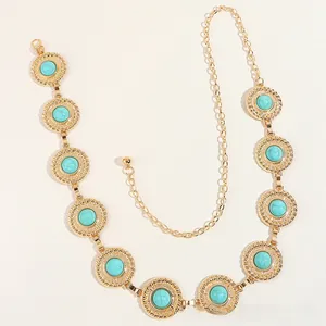 Detail of bohemian gold metal waist chain featuring inlaid turquoise medallions