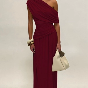Detail view of burgundy one-shoulder maxi dress with elegant pleats and ruched slim waistline