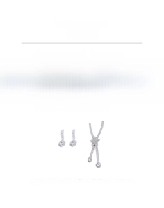 Macro shot of silver-toned fringe necklace with star element and rhinestone earrings