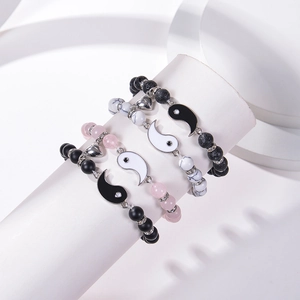Detail of Yin Yang beaded bracelets with heart magnets and marble beads in a 4-piece set