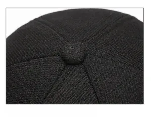 Detailed close-up of the six-panel crown and top button on a black wool baseball cap