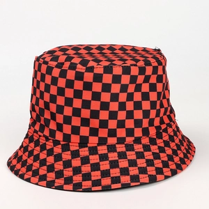 Detail view of the red and black checkered pattern on a reversible cotton bucket hat