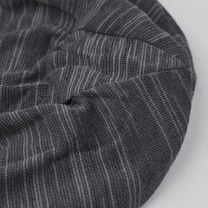 Detailed close-up of the dark grey striped knit fabric on this breathable beanie hat