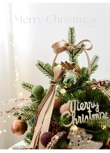 Close-up of luxury champagne Christmas tree with felt balls, pine cones and LED lights