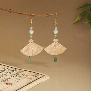 Detail of Chinese style butterfly earrings with pearl tassels on a natural branch