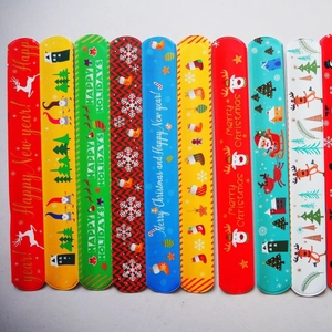 Set of 12 colorful Christmas slap bracelets with festive reindeer and Santa patterns