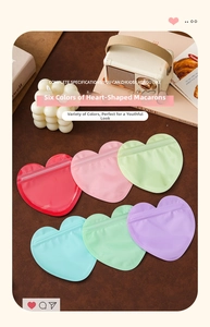 Macro detail of heart-shaped macaron resealable bags in six colors on leather background
